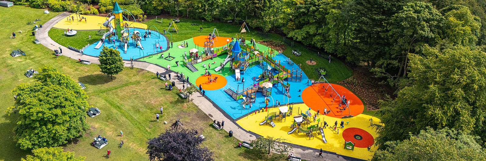 Ariel view of a large and colorful playground unit which is accessible and inclusive.